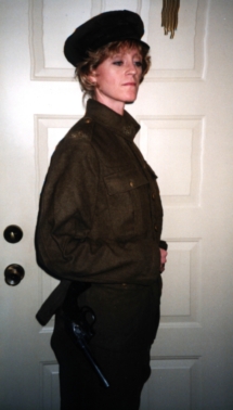 Deanna DiCola with WWI uniform and pistol hung on belt shows damaged cylinder.